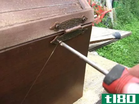 Image titled Installing the hinge screws. A screw gun or drill with a driver bit can make this job easier.