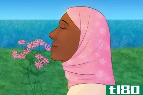 Image titled Woman in Hijab Smells Flowers.png