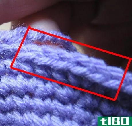 Image titled Two stitches in one row and one in the next. The rows are horizontal in this photo.