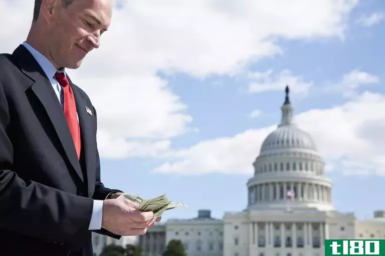 A politician counting money in front of the US Capitol Building.