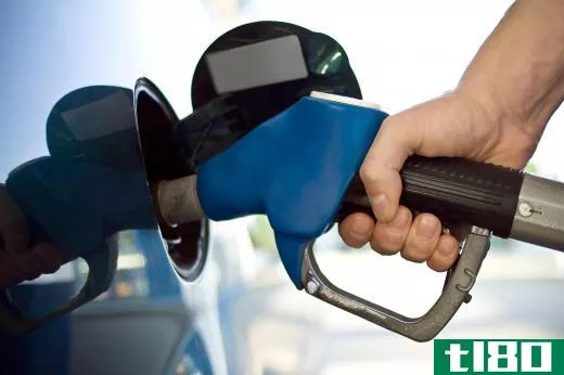 A man filling up his gas tank. Gasoline-powered cars release carbon dioxide into the atmosphere.