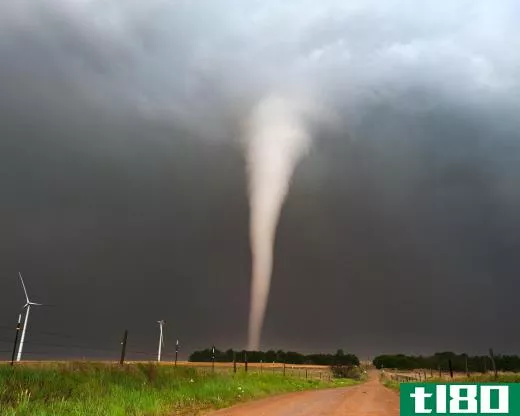 A tornado appears as a funnel shape in the sky.