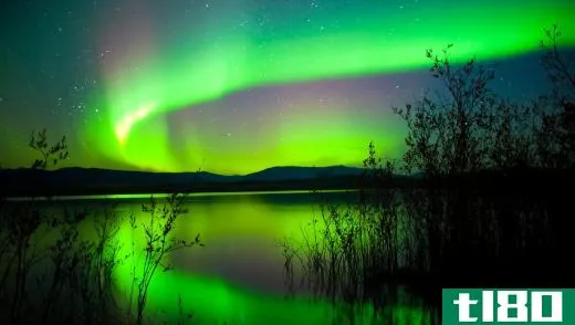 The Aurora Borealis reflecting off a still lake.