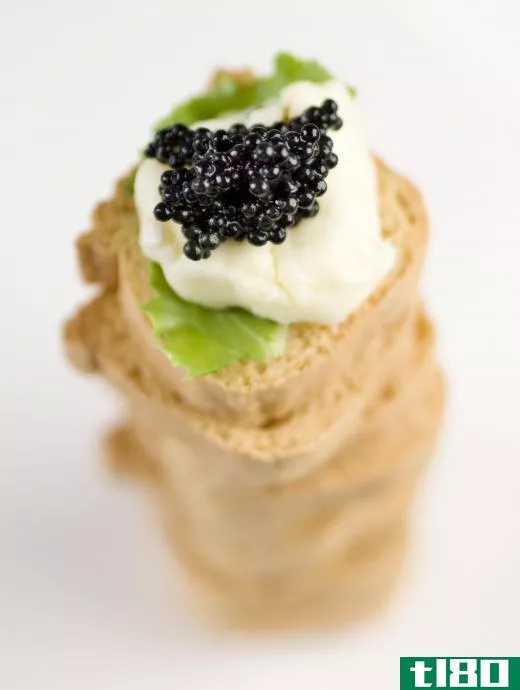 Caviar appetizer with crème fraîche and basil.