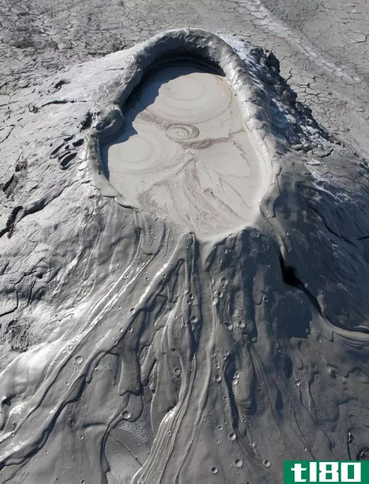The extrusion of pressurized gases and mud below Earth's crust forms mud volcanoes.