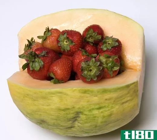 Strawberries inside a crenshaw melon, a type of curcumis melo.