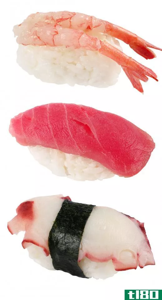 Nigiri sushi assortment with one piece wrapped with seaweed.