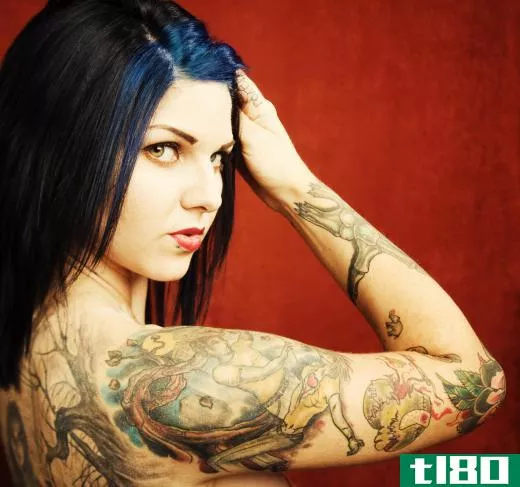 Woman with tattoos on her arm and back.