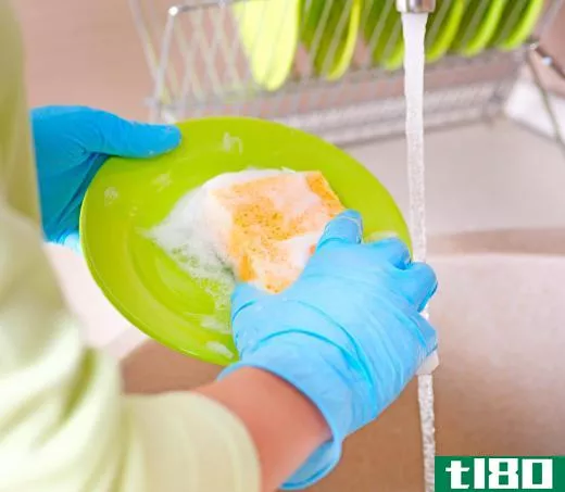 Wearing gloves while washing dishes may help improve nail growth.