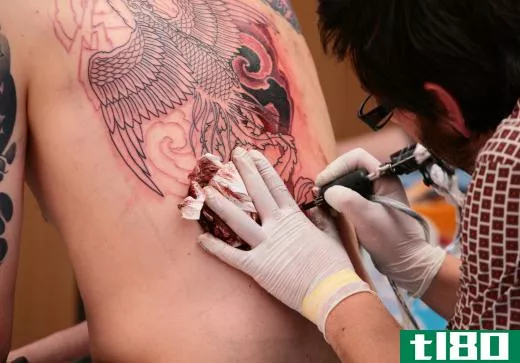 Large tattoo being applied.