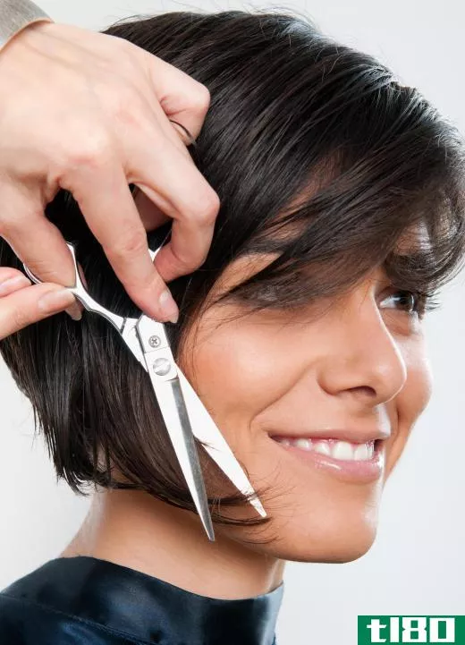 A hairstylist cutting dry hair.