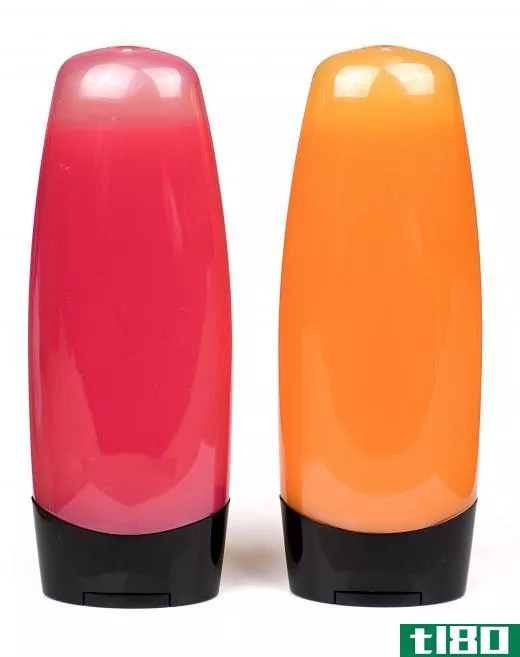 Bottles of pink and orange shower gel.