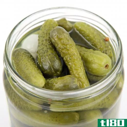 A jar of pickled cornichons, a small cucumber.