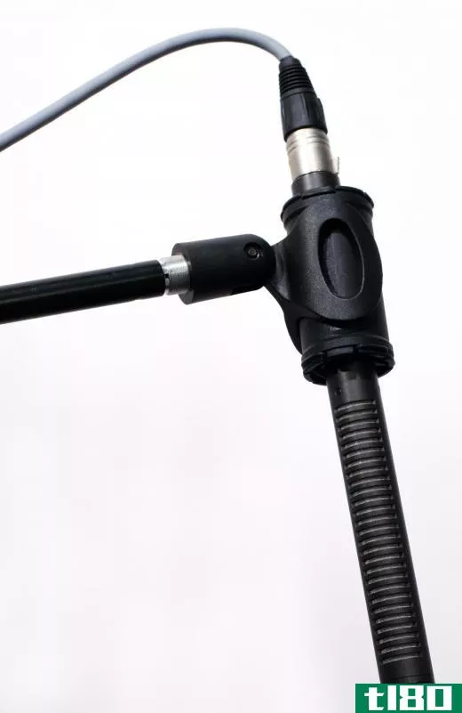 A boom microphone is mounted or attached to a pole or arm.