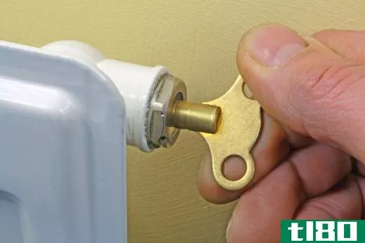 A radiator key opens the bleed valve to release excess air.