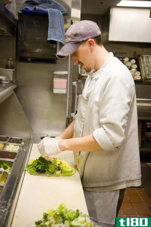 A line cook may be tasked with preparing salads and entres.