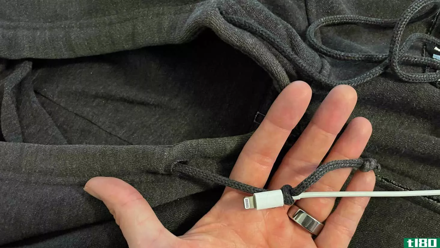iPhone cable after pulling the drawstring through the hoodie. 