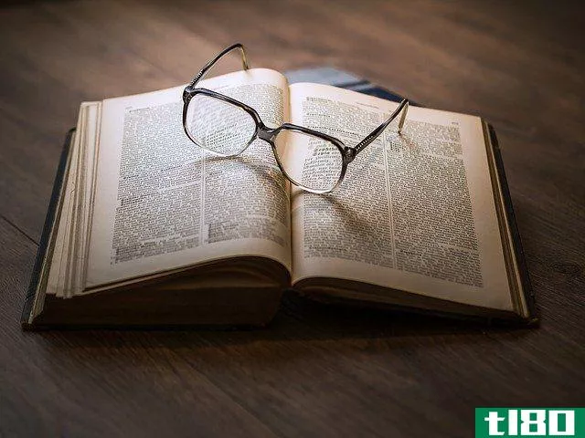 glasses on top of open book