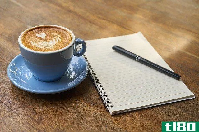 coffee cup, pen and notebook