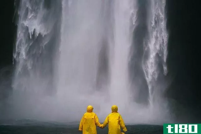 Couple wearing matching yellow raincoats