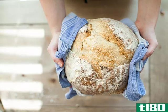 hands holding a loaf of bread