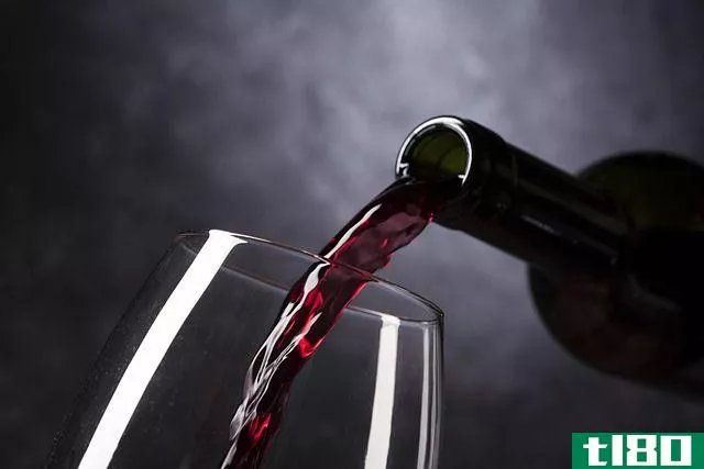 wine being poured from wine bottle into glass