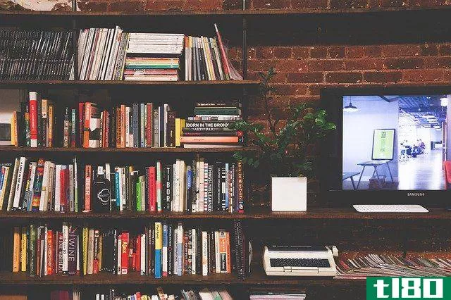 tv and bookshelf on brick wall