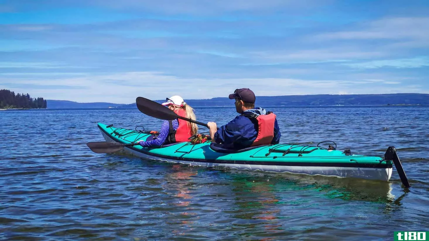 Kayakers wearing personal flotation devices (PFDS).