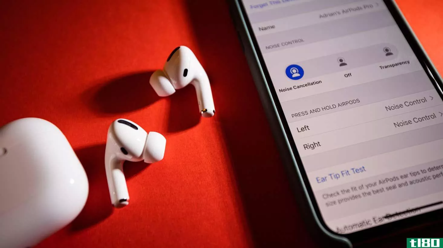 A decorative image of AirPods Pro on a table next to an iPhone displaying the bluetooth settings