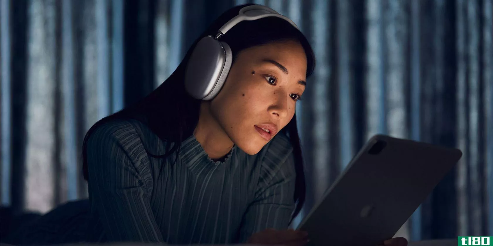 Woman staring at a screen and listening to AirPods Max