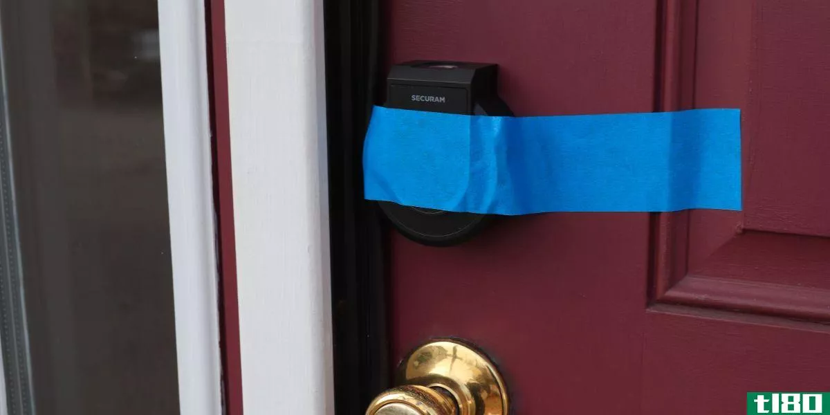 Securam Smart Lock Taped Up on Red Door
