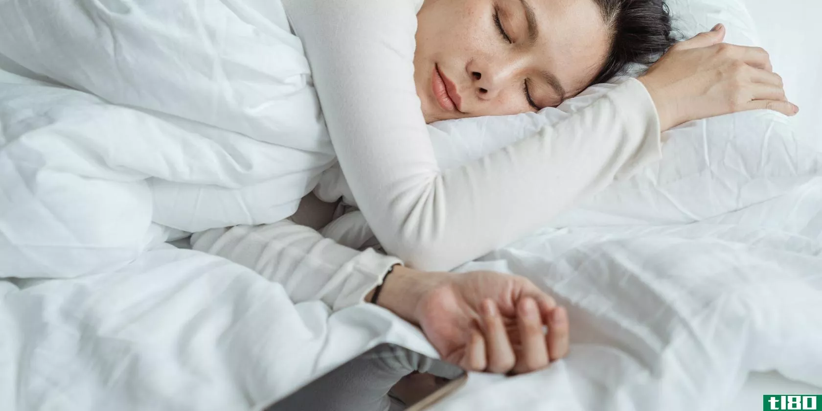 woman sleeping next to a **artphone