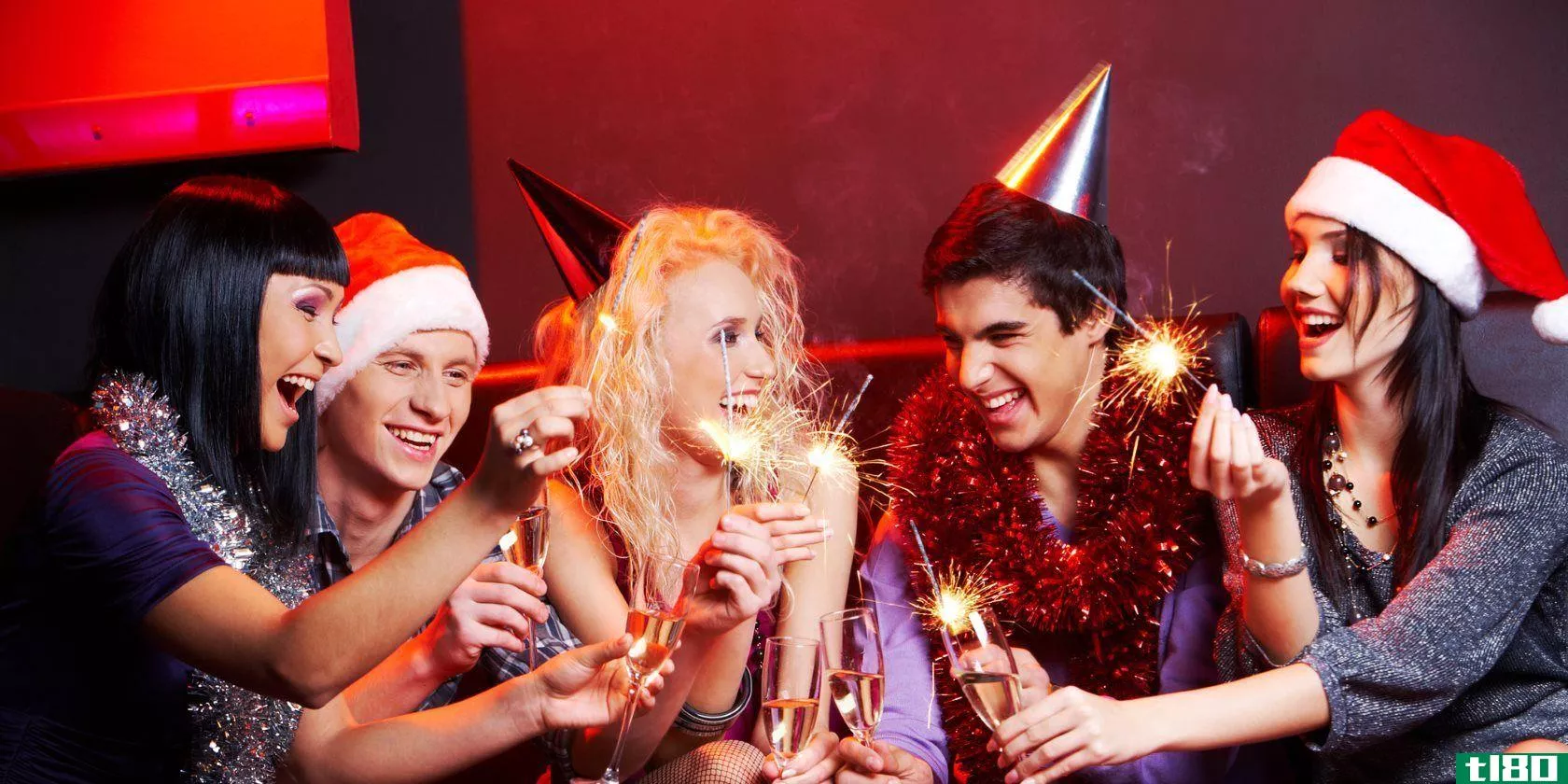 portrait-of-laughing-friends-enjoying-xmas-lights-at-new-year-party