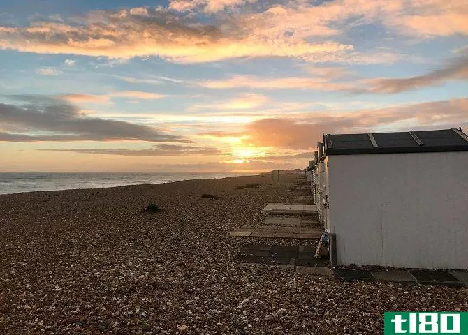 sunset on beach with sheds