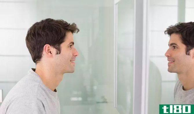 man looking at self in mirror