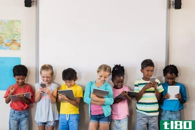 children holding tablets