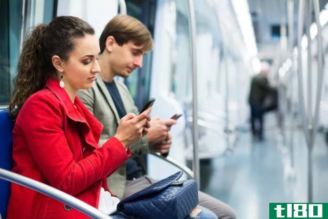 people on phones subway