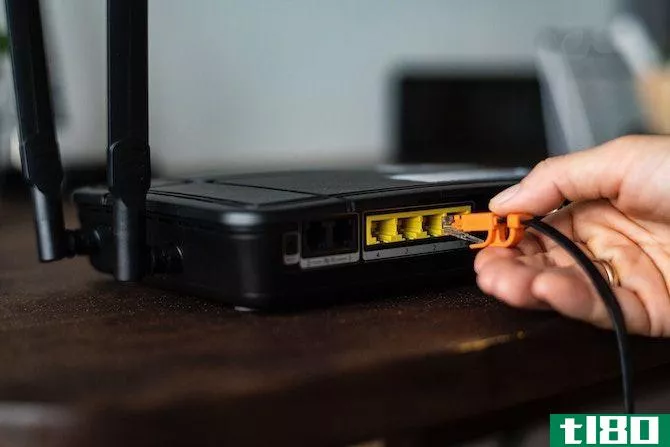 User reinserting cable into Wi-Fi router
