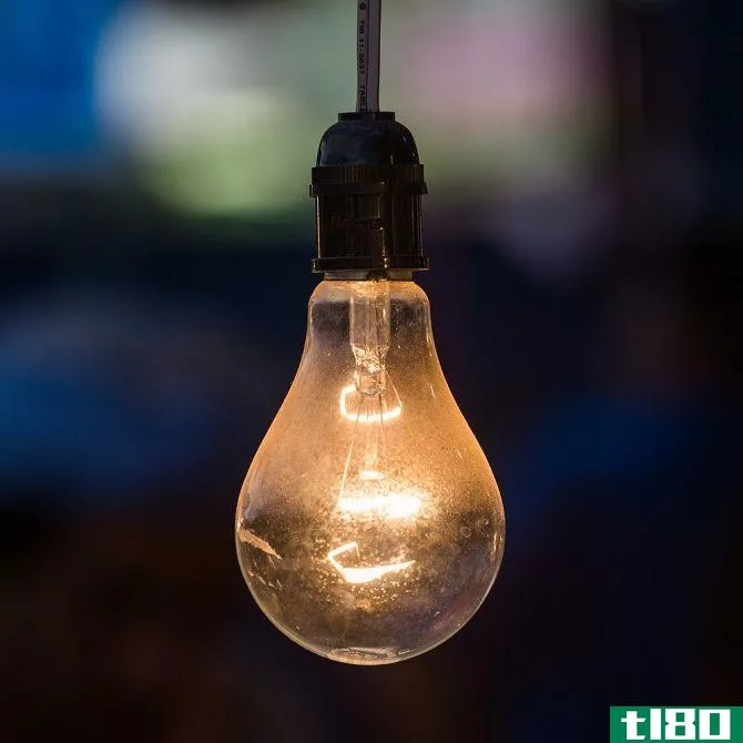 old light bulb glowing in dark