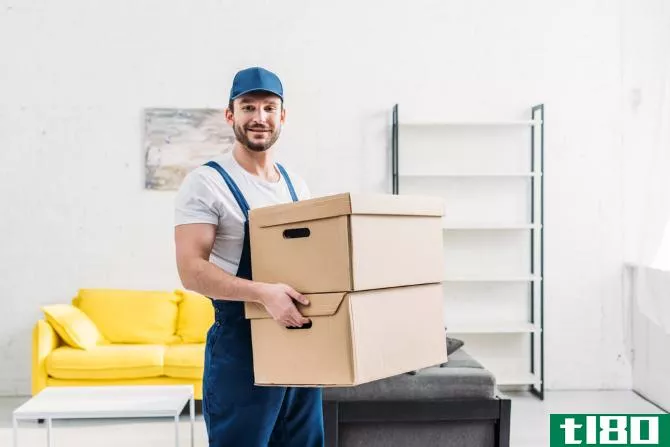 A mover moving furniture into a new home