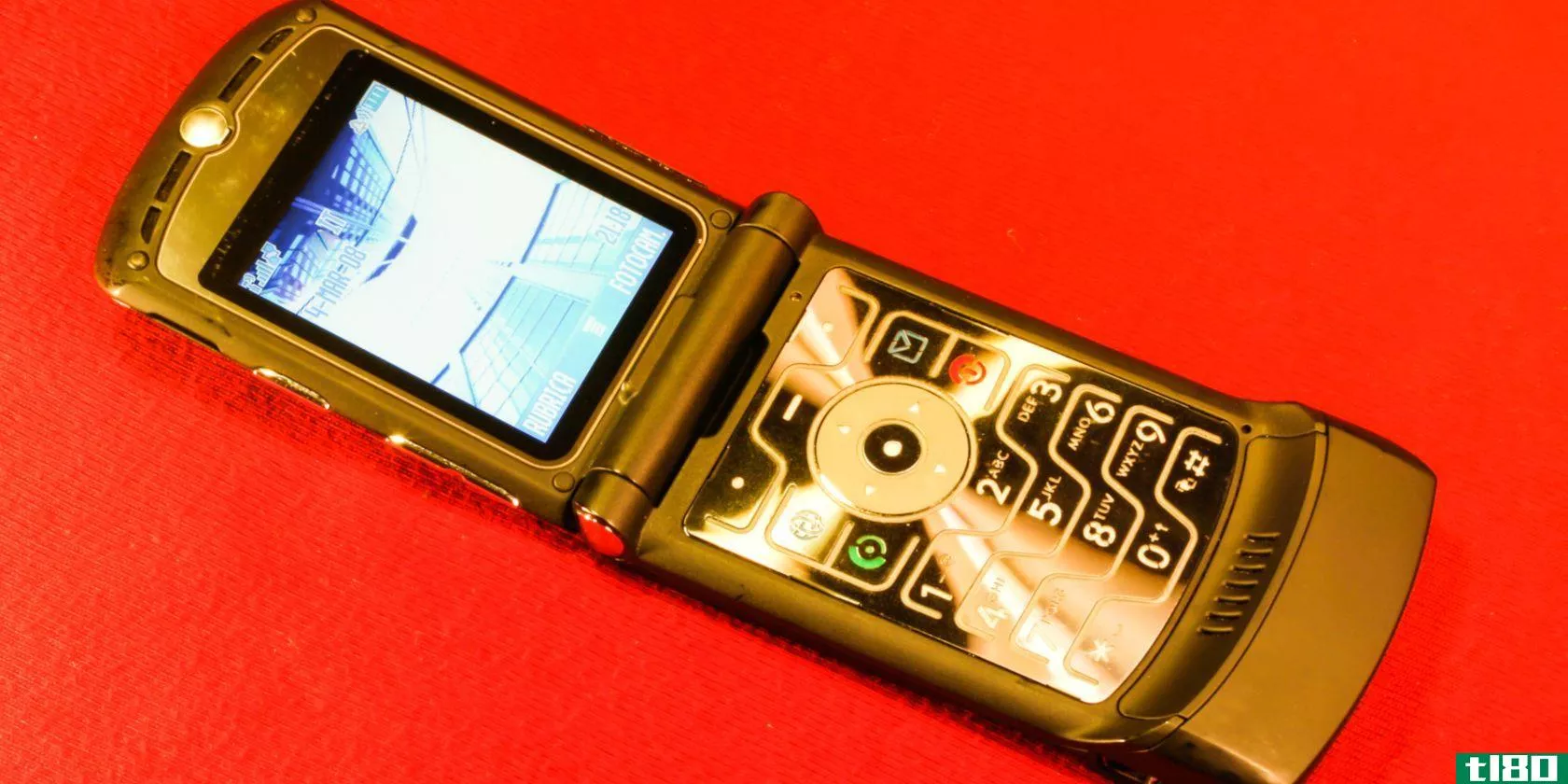 A motorola Razr phone on a red background