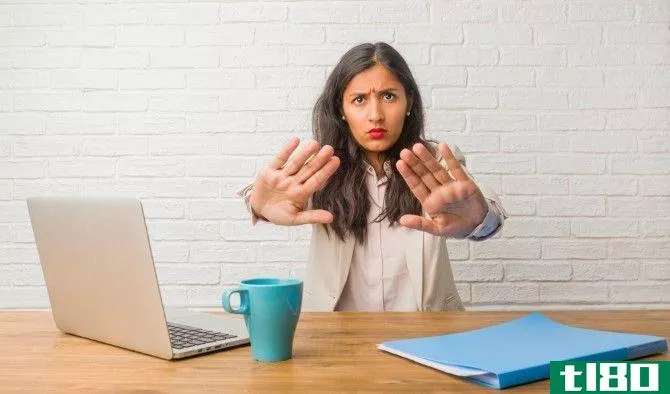 Woman at the office making a stop gesture with hands