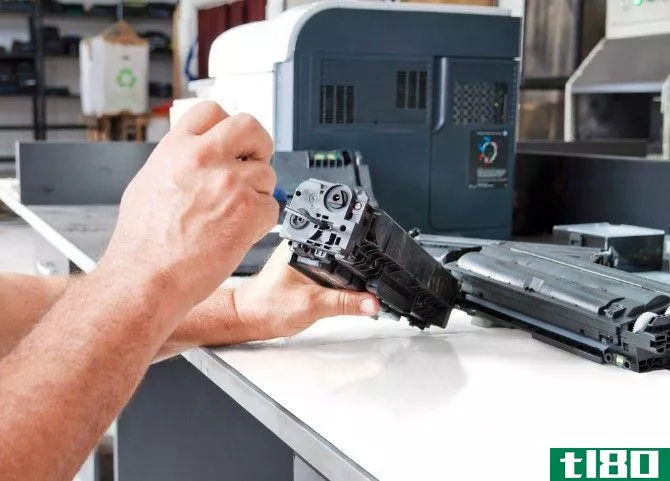 Hands repairing laser toner cartridge