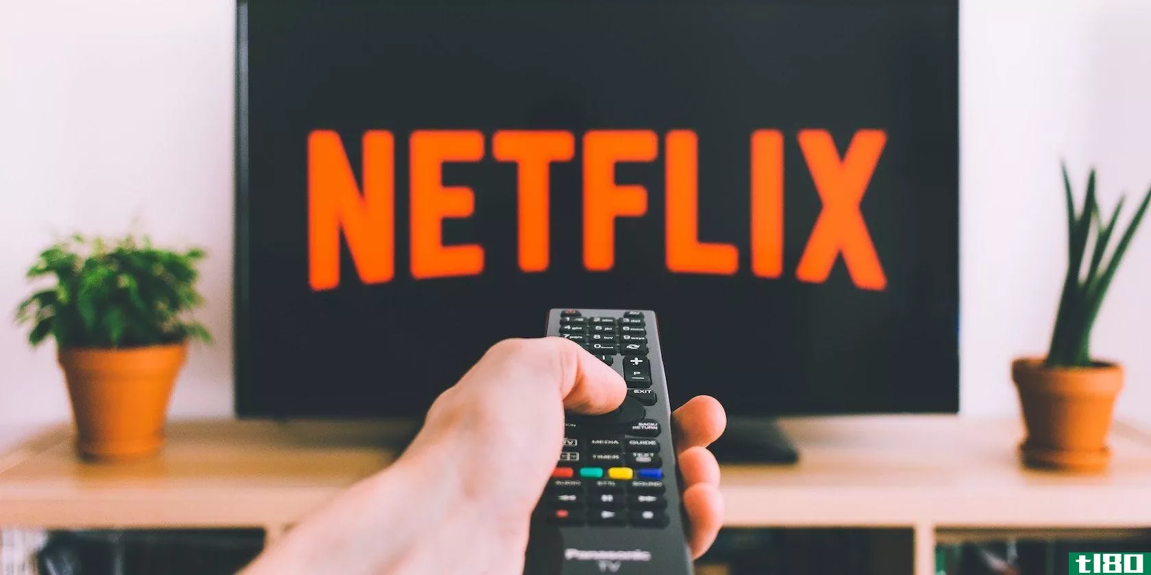 Guy pointing remote at Netflix on TV