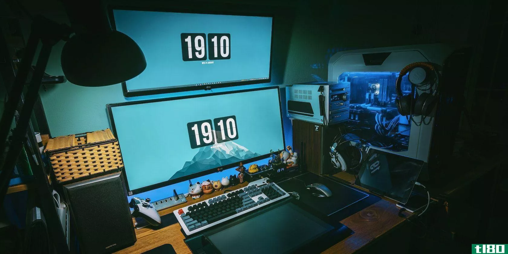 A gaming rig with two monitors displaying the time 