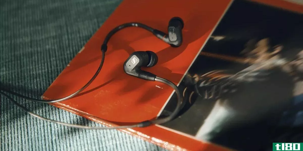 Sennheiser IE 300 in-ear headphones curled on LP record.
