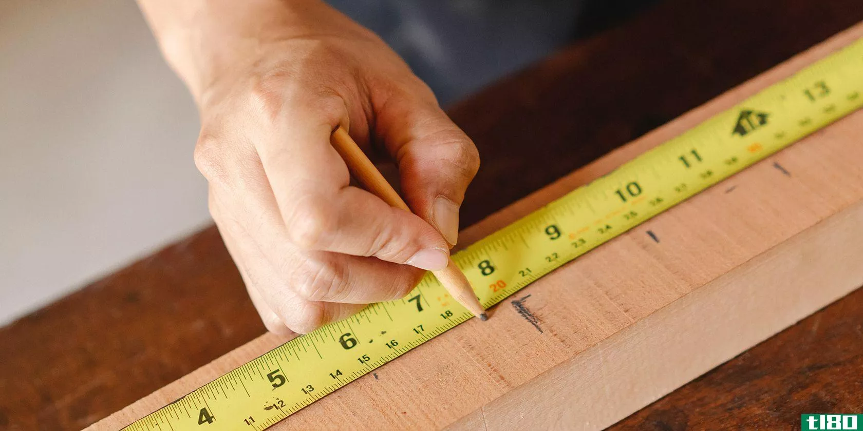 person-using-yellow-tape-measure