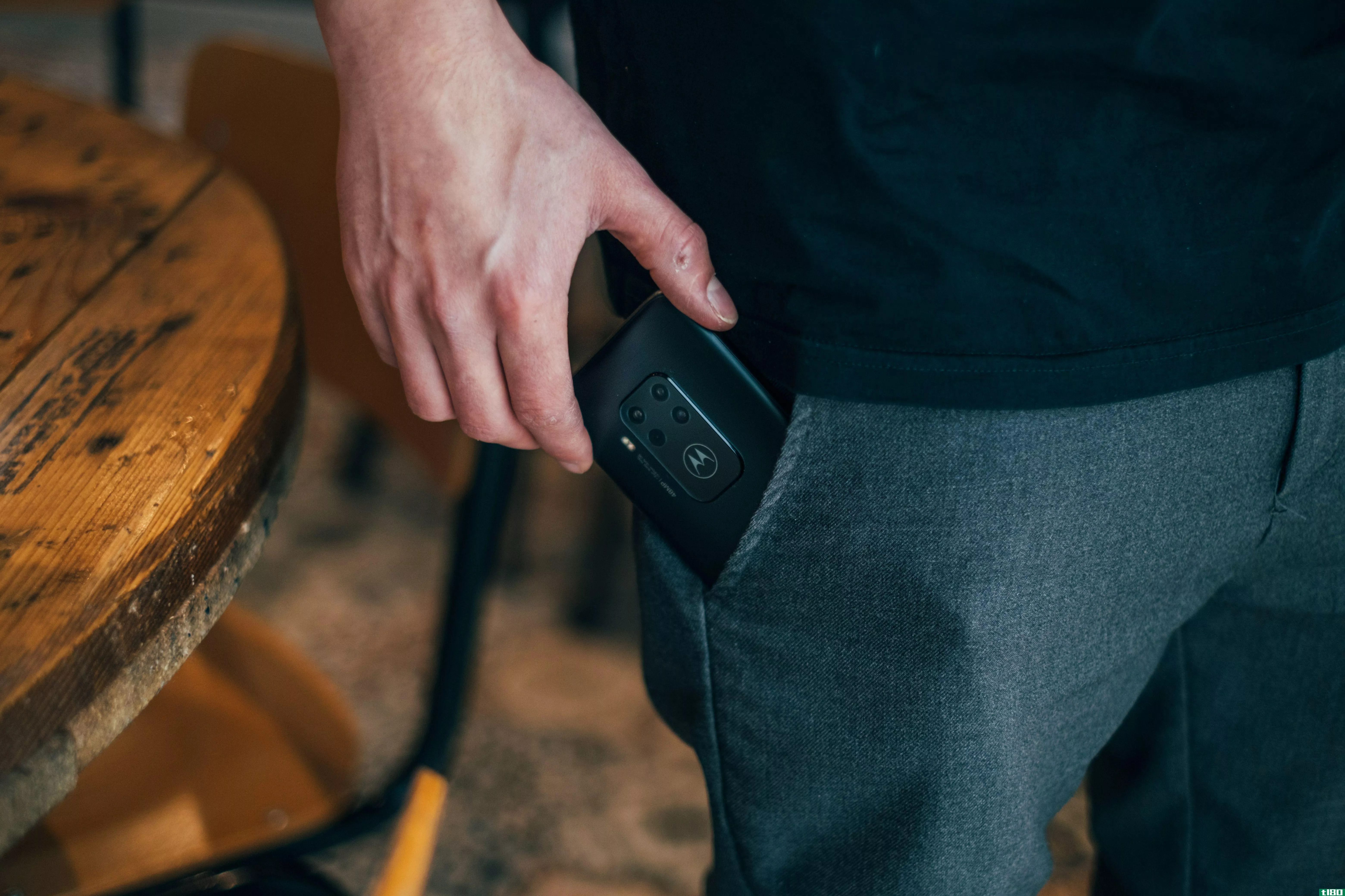 A Motorola phone being put into a pocket where lint and dust could accumulate inside the audio jack