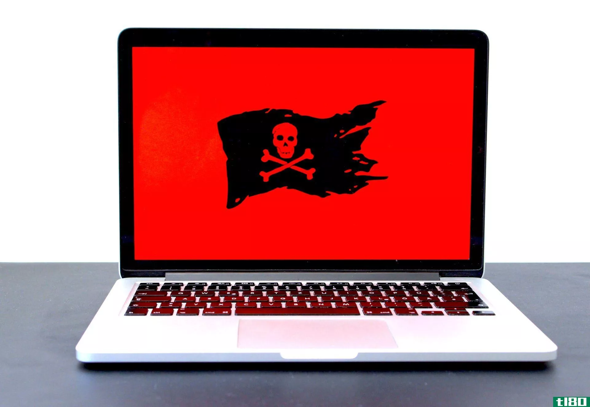 Laptop with a red screen and black pirate flag