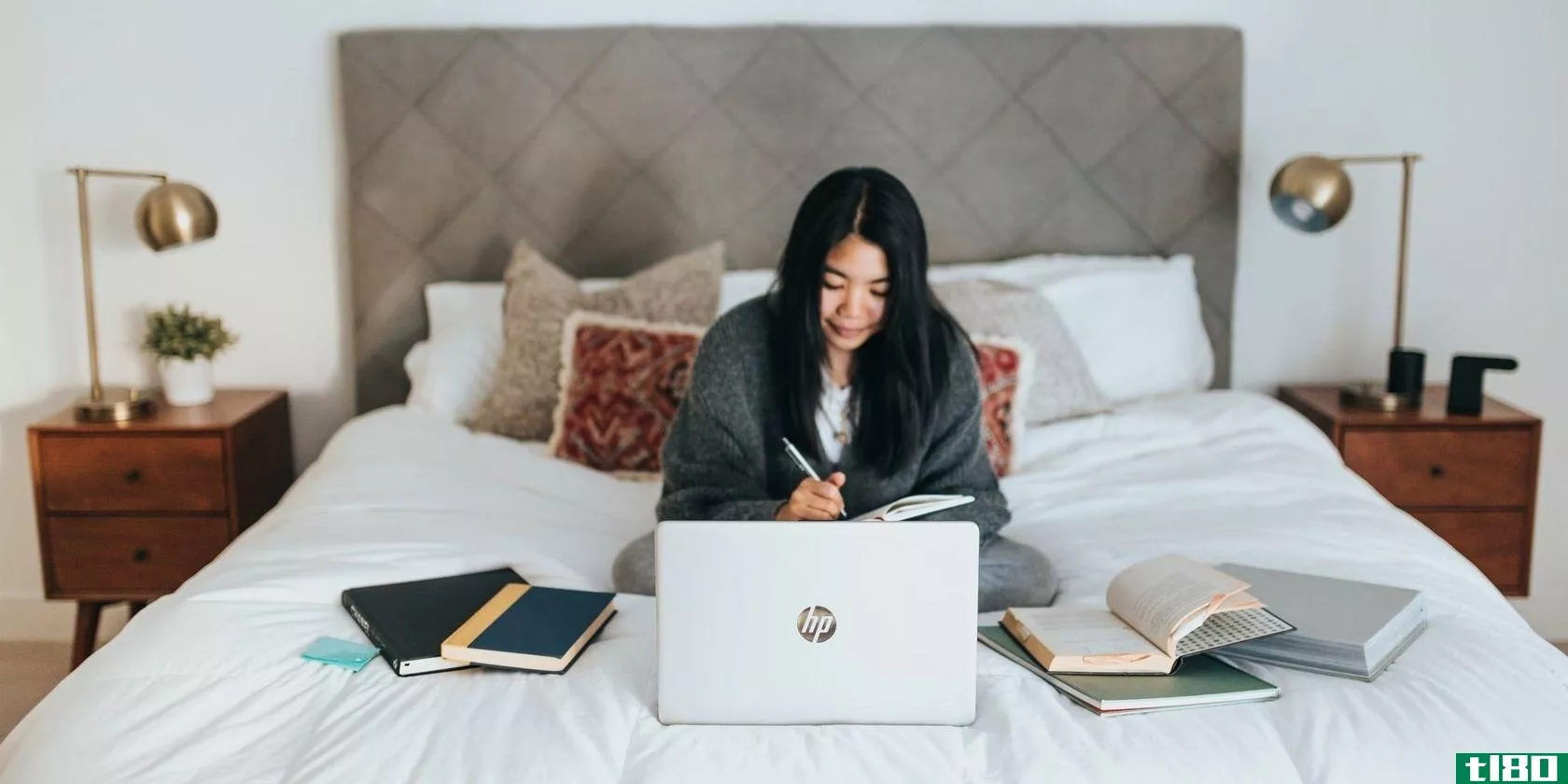 Girl using a laptop on her bed